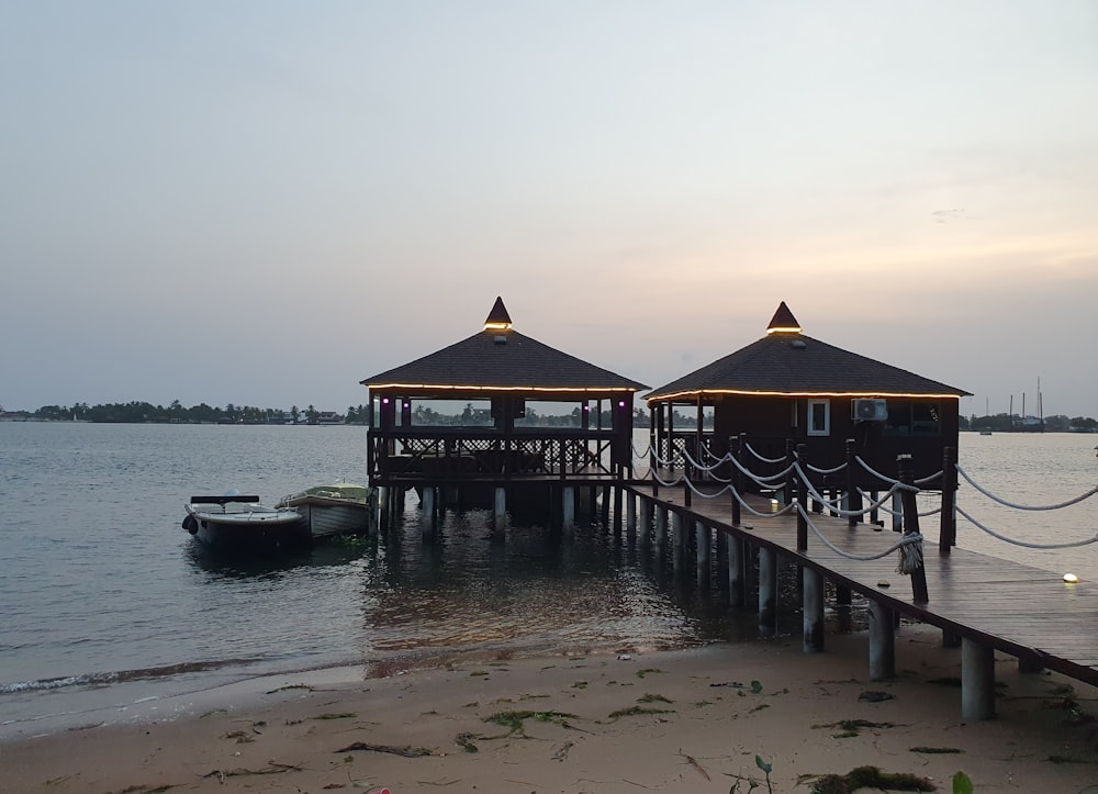 a pier with two small huts on top of it