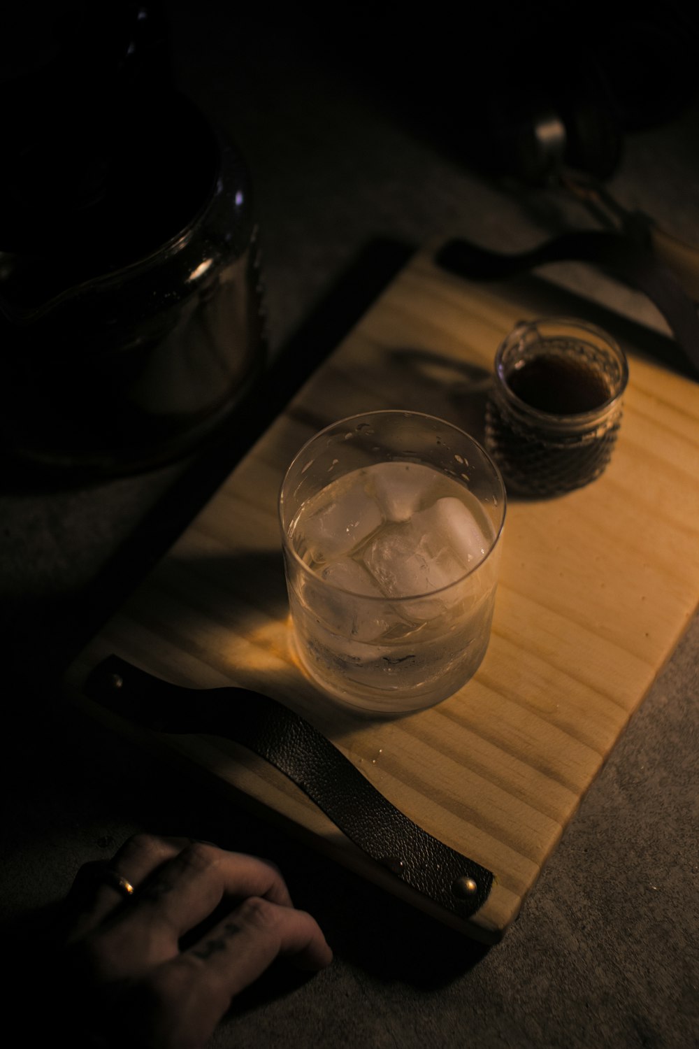 a wooden cutting board topped with a bowl of ice