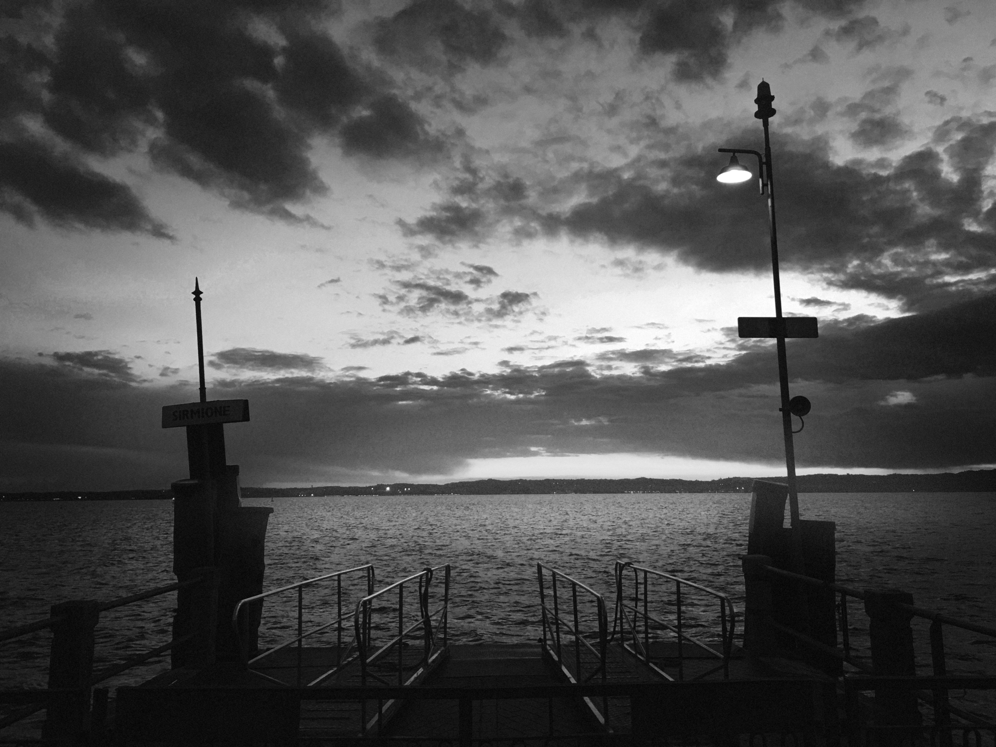 a black and white photo of a pier