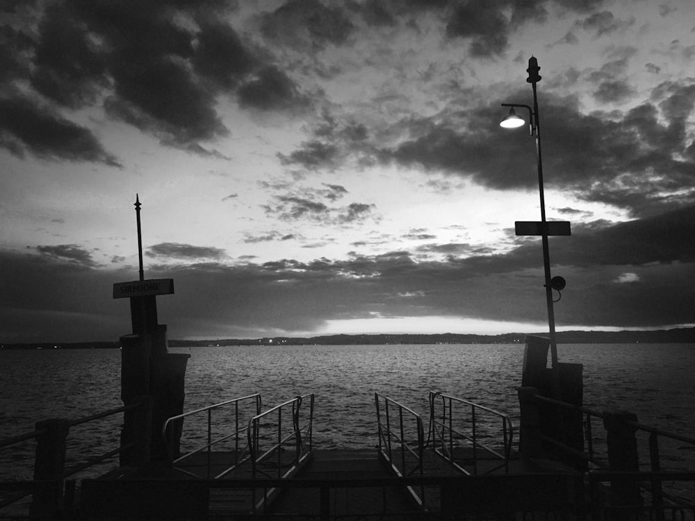 a black and white photo of a pier