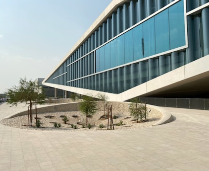 a large building with a curved walkway in front of it