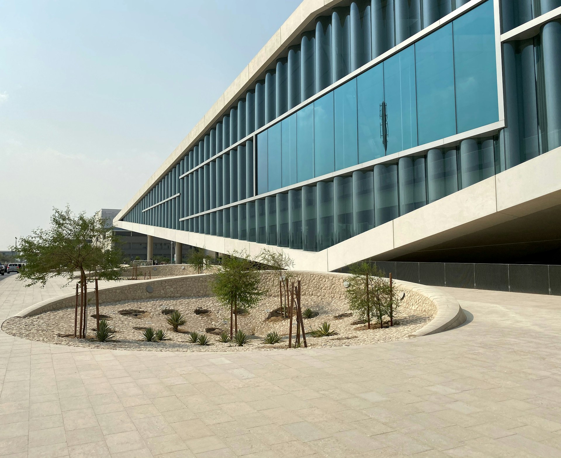 a large building with a curved walkway in front of it