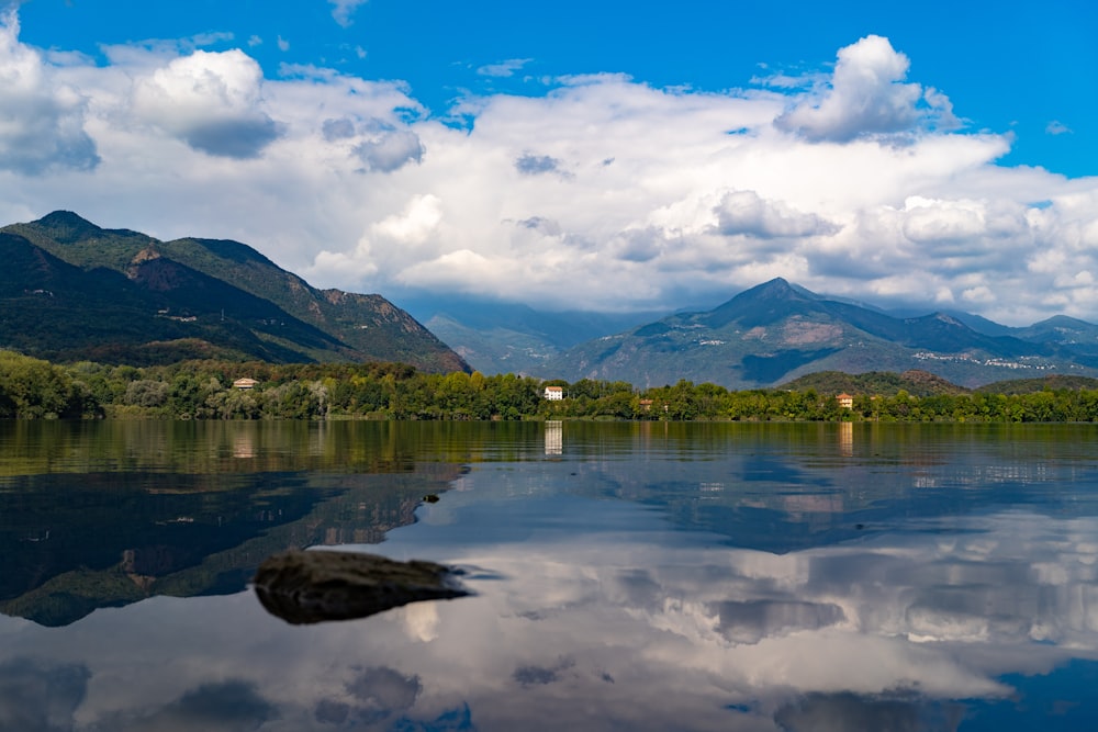 a body of water with mountains in the background