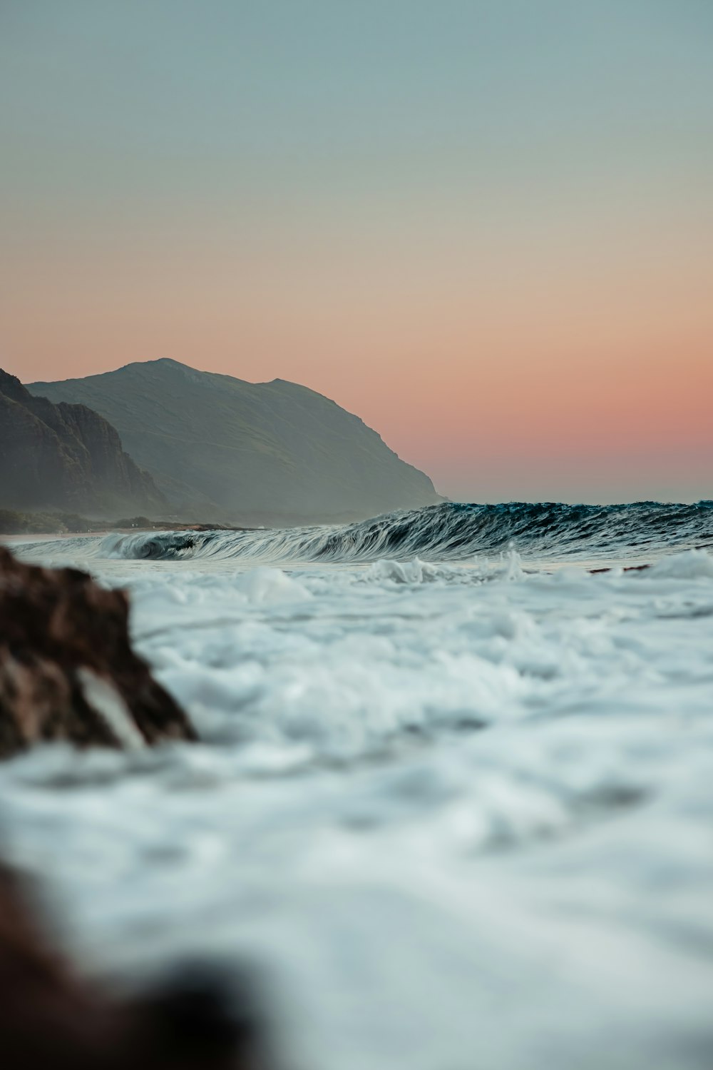 a body of water with a mountain in the background