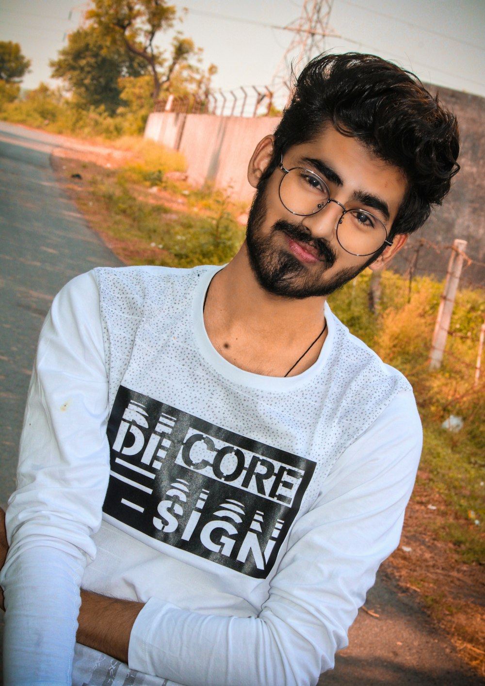 a man with a beard and glasses posing for a picture