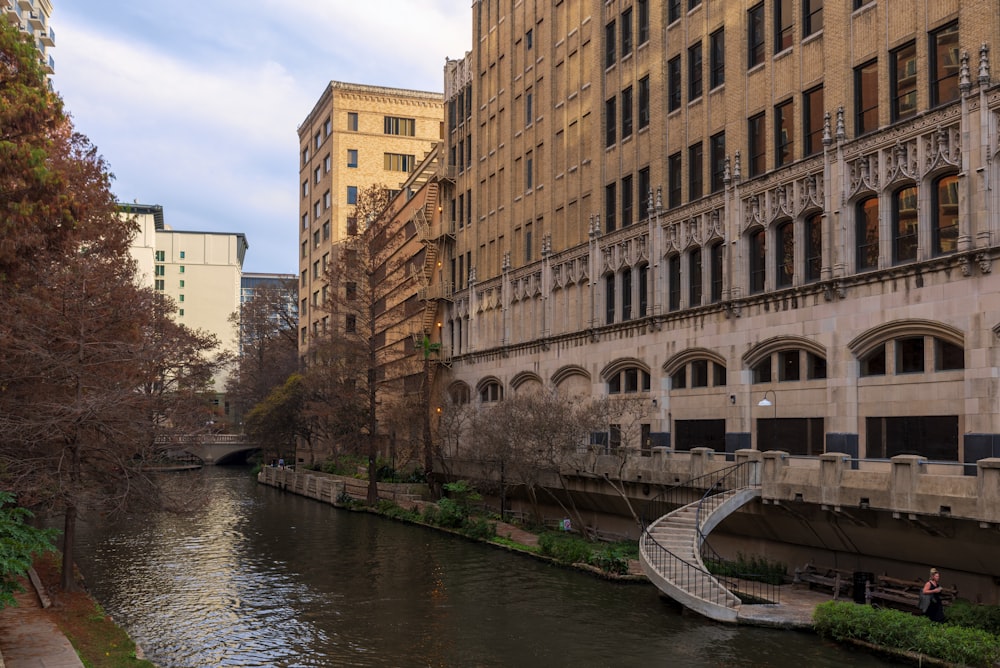 a river running through a city next to tall buildings