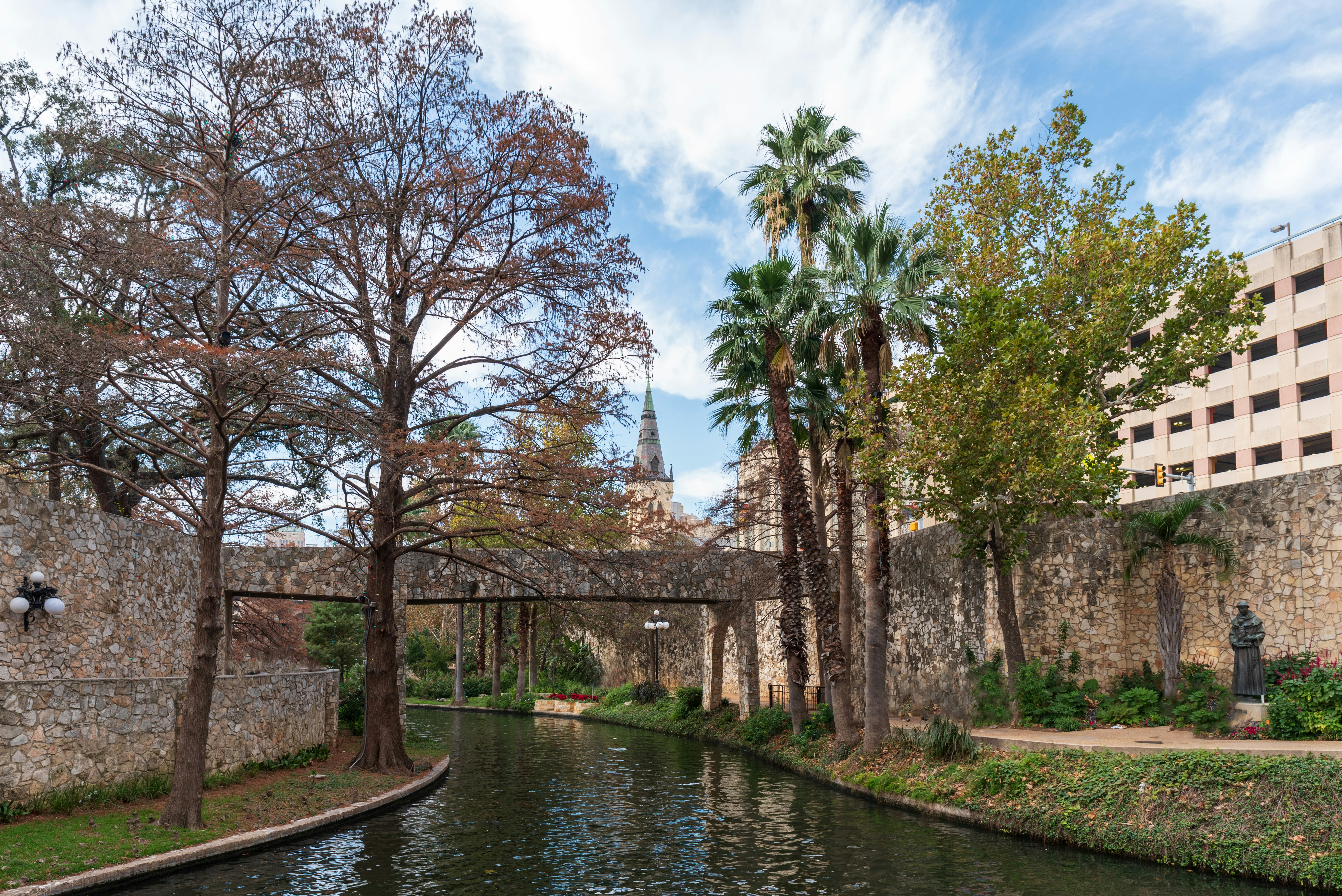 a river running through a lush green park