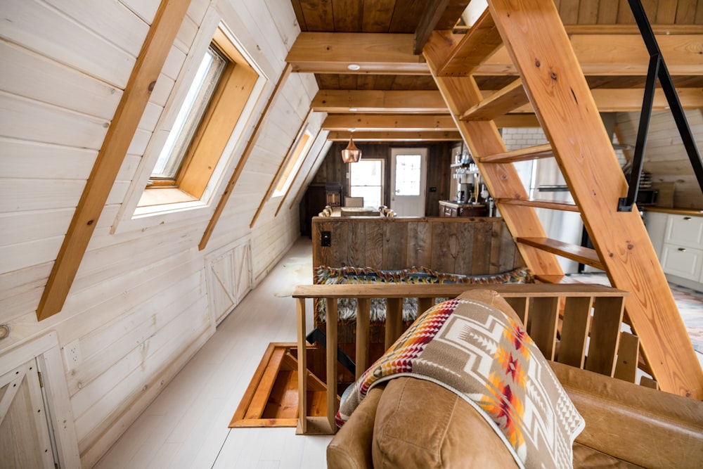 a living room with a couch and a stair case