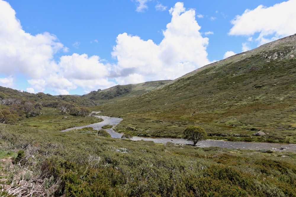 a scenic view of a winding road in the mountains