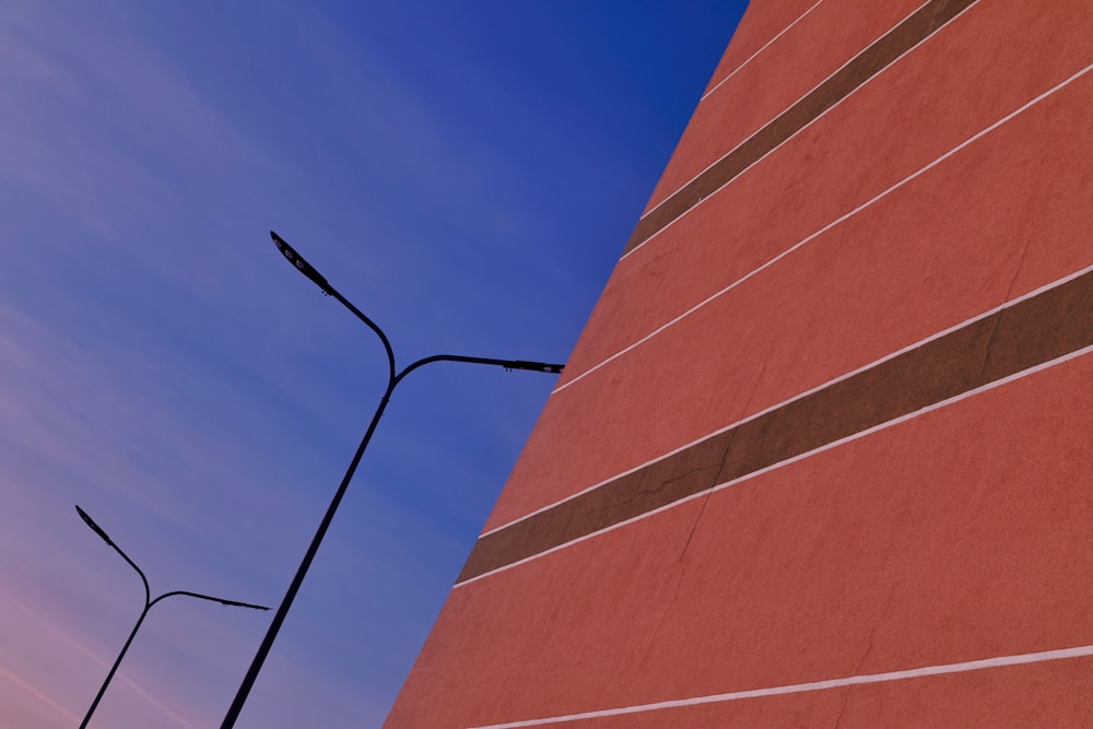 a tall red brick building next to a street light