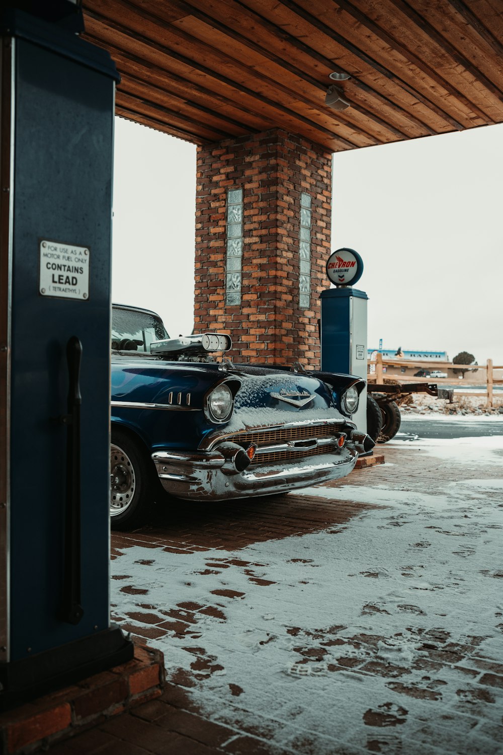 an old car is parked under a building