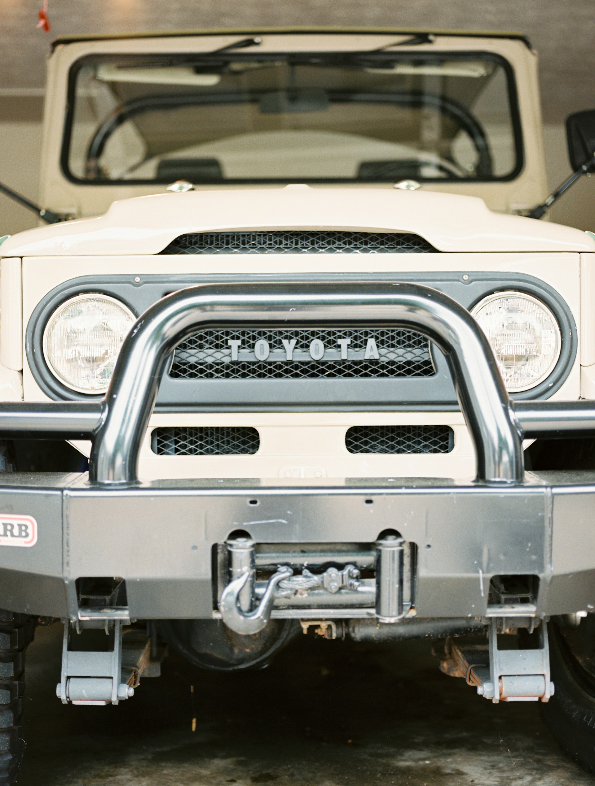 a white jeep is parked in a garage