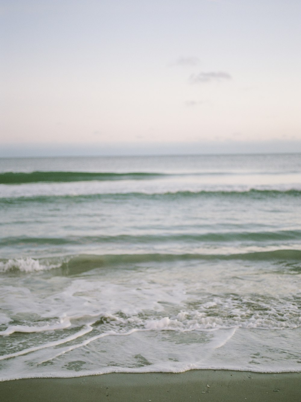 a surfboard sitting on top of a sandy beach