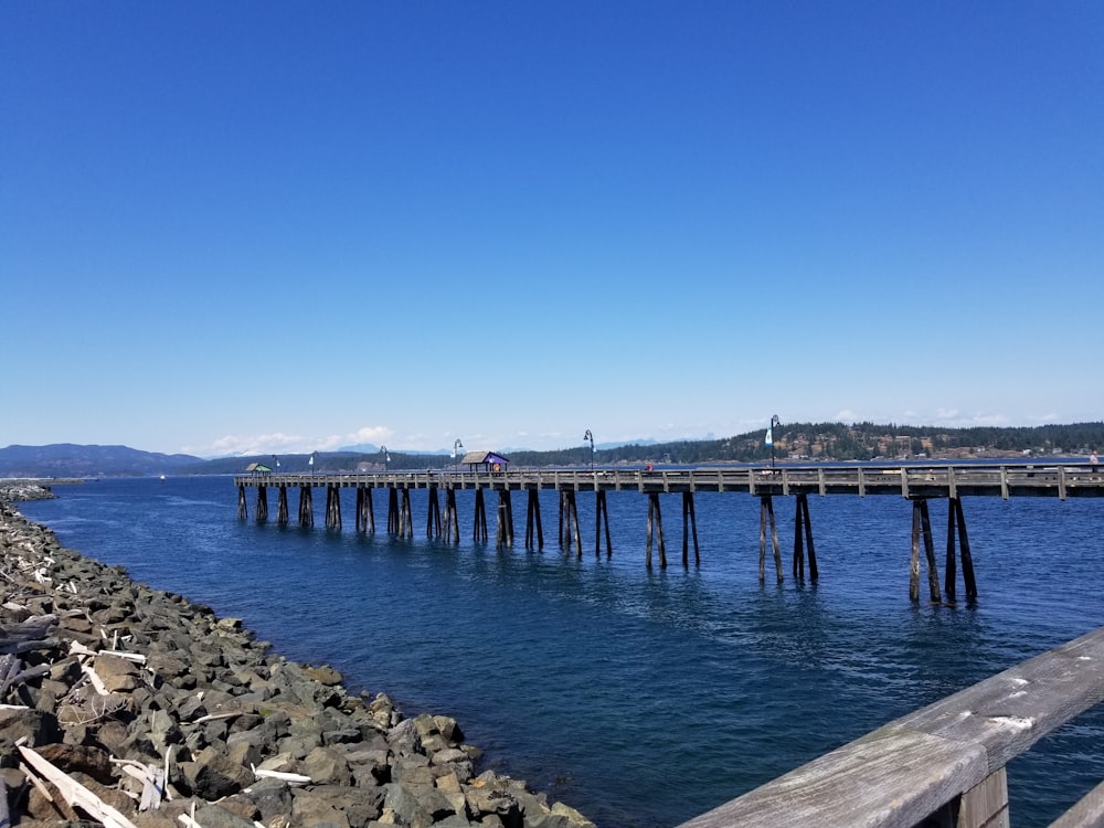 a long wooden pier sitting next to a body of water