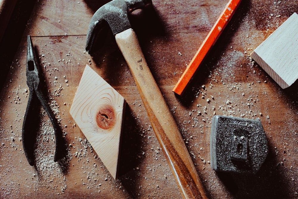 a hammer and a pair of pliers on a table