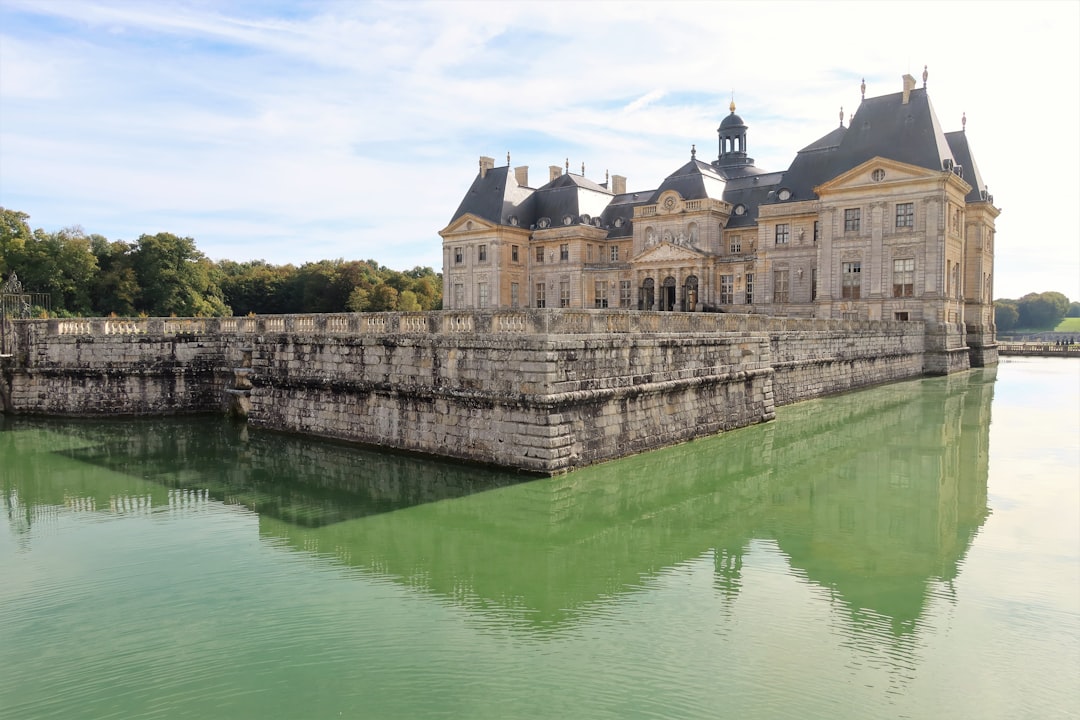 a large building sitting next to a body of water,