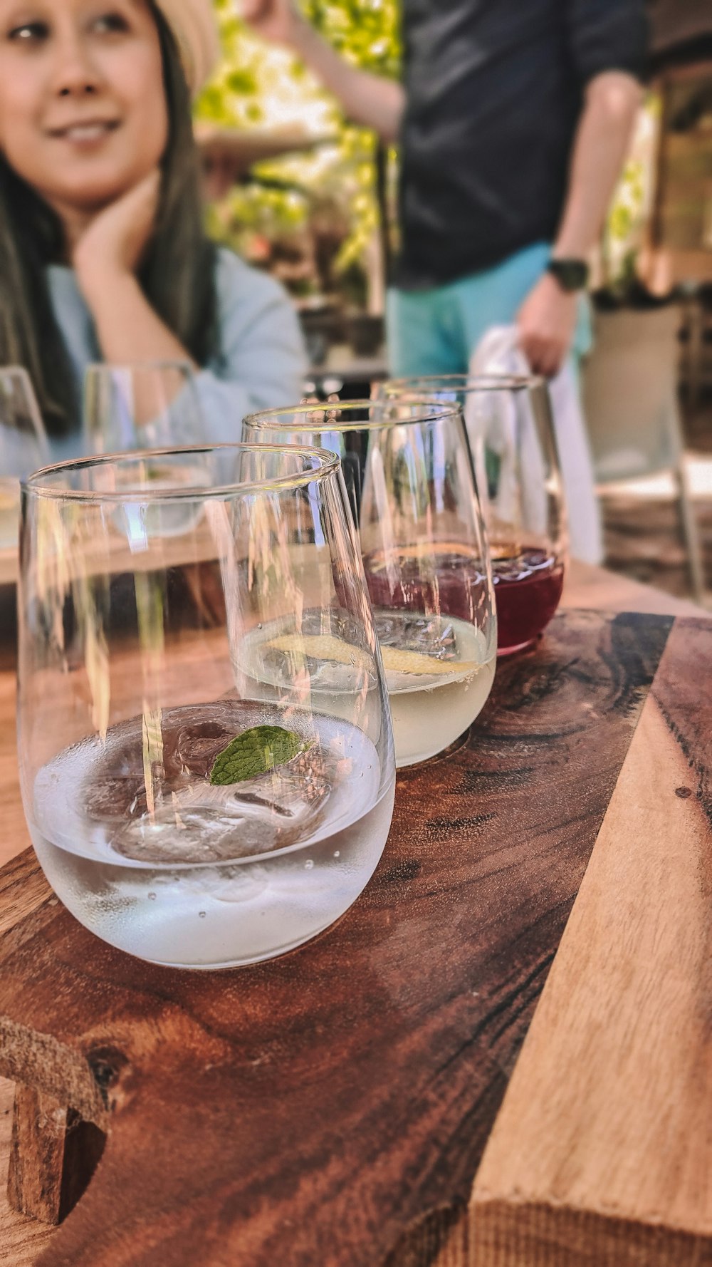 a group of wine glasses sitting on top of a wooden table