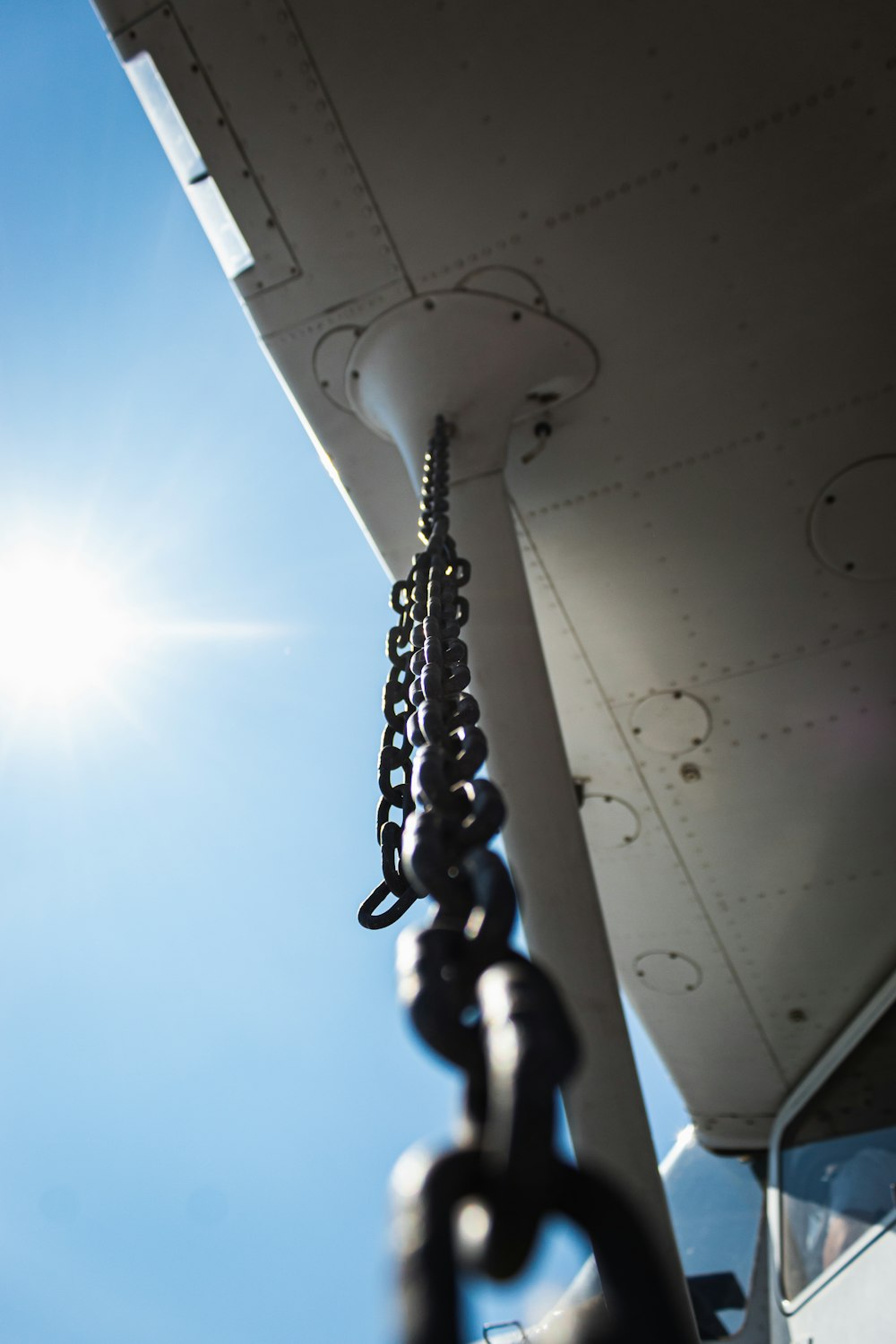 a close up of a chain attached to a plane