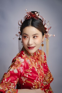 a woman in a red dress with a flower in her hair