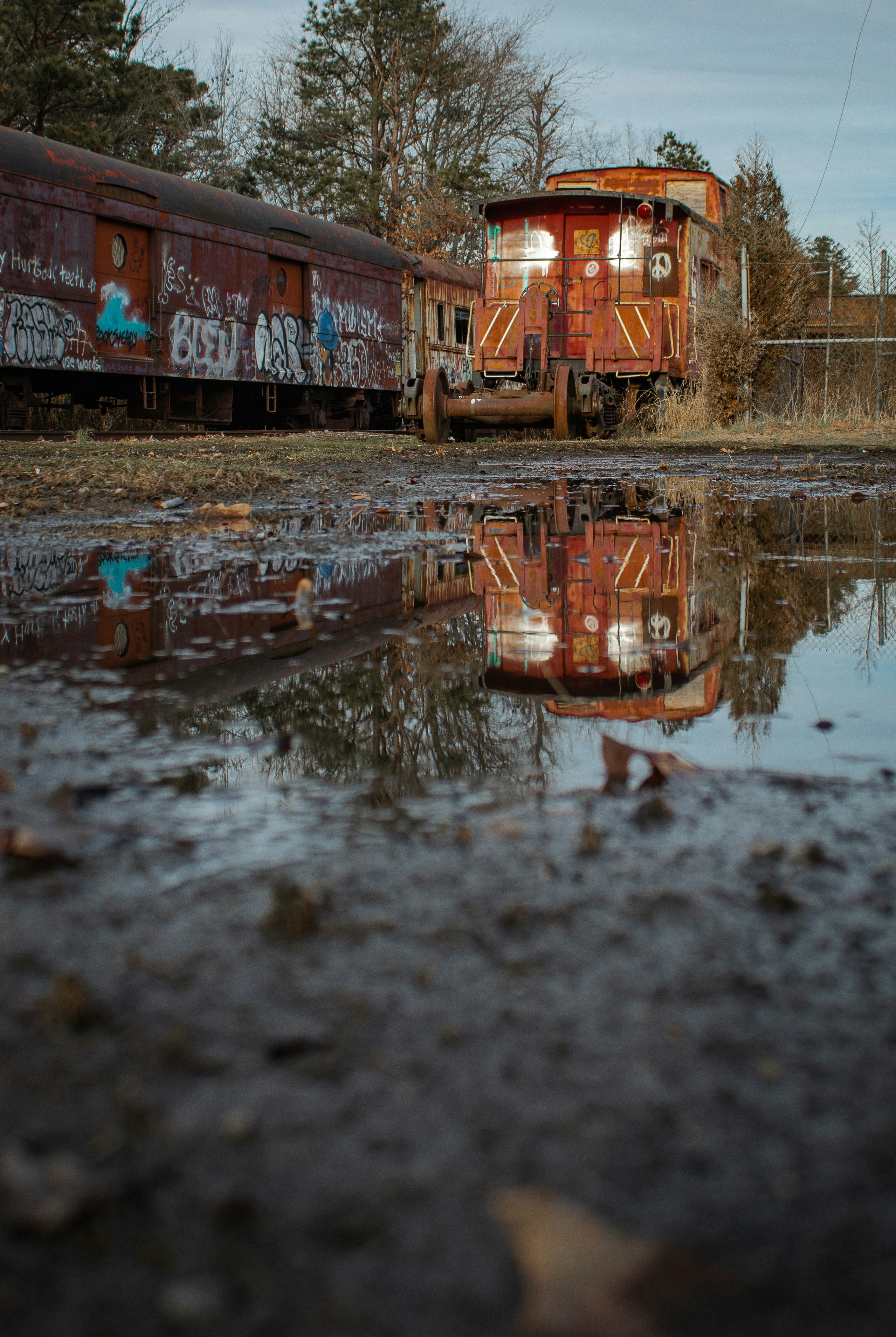 Two train cars sitting next to each other on a track photo – Free ...