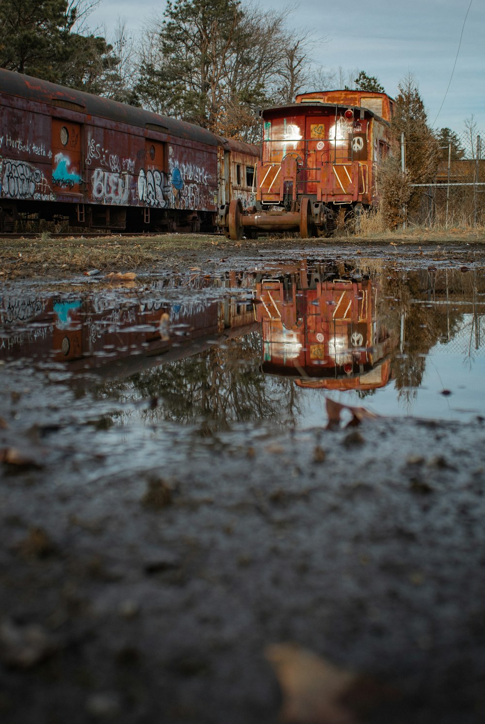 two train cars sitting next to each other on a track