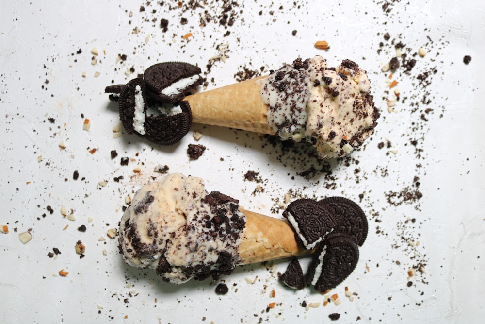 two ice cream cones with oreo cookies on them