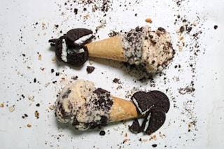 two ice cream cones with oreo cookies on them