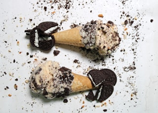 two ice cream cones with oreo cookies on them