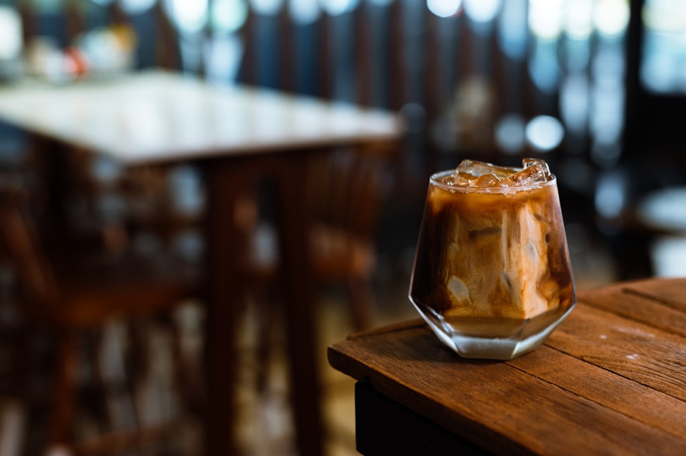 a drink sitting on top of a wooden table