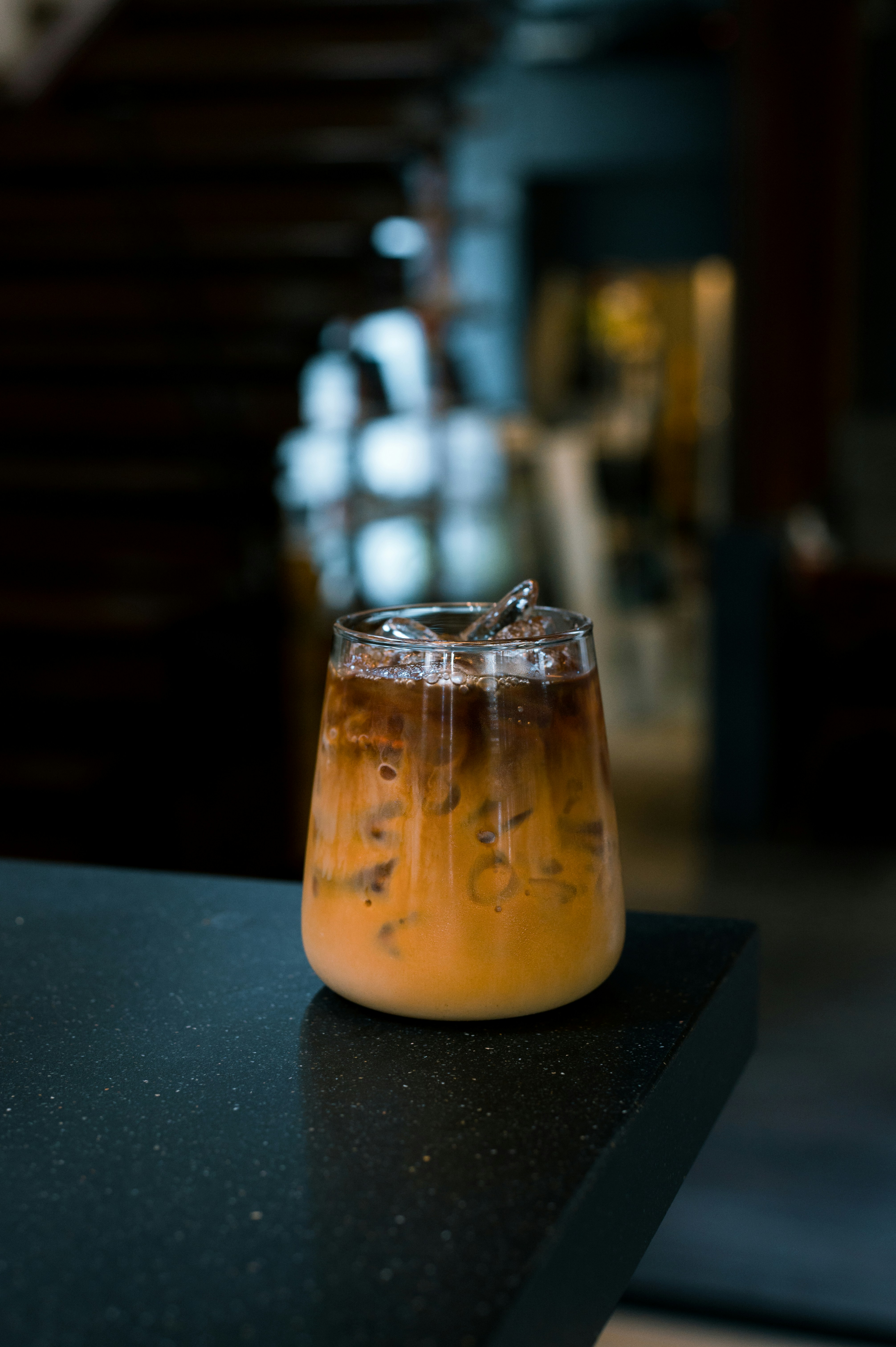 a glass filled with liquid sitting on top of a counter