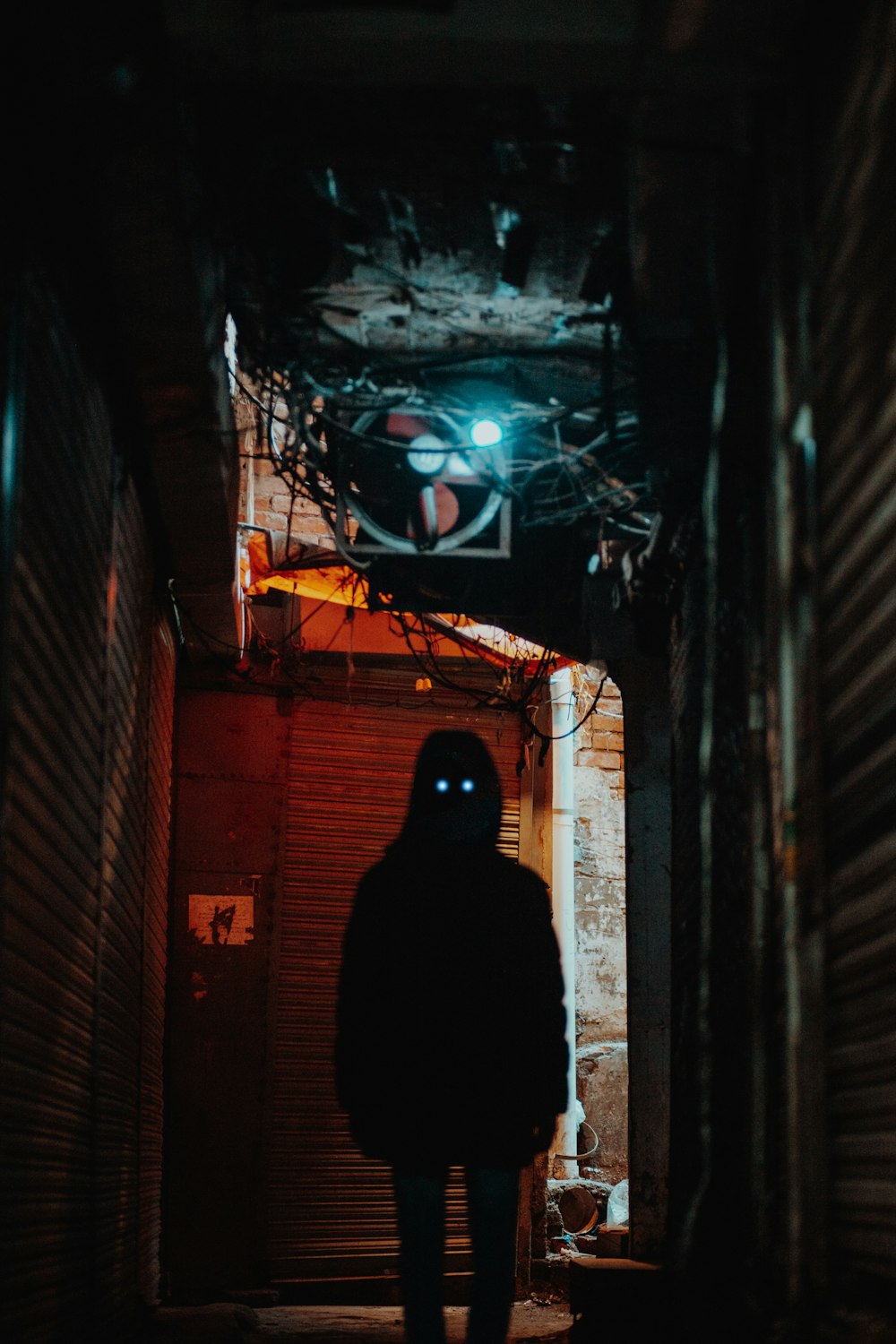 a person standing in a dark alley way