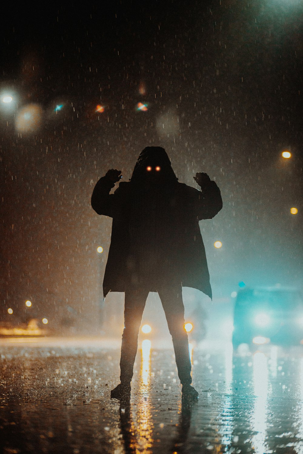 a person standing in the rain at night