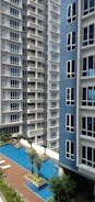 a swimming pool in front of a tall building
