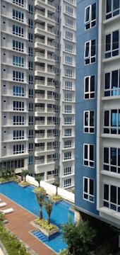 a swimming pool in front of a tall building