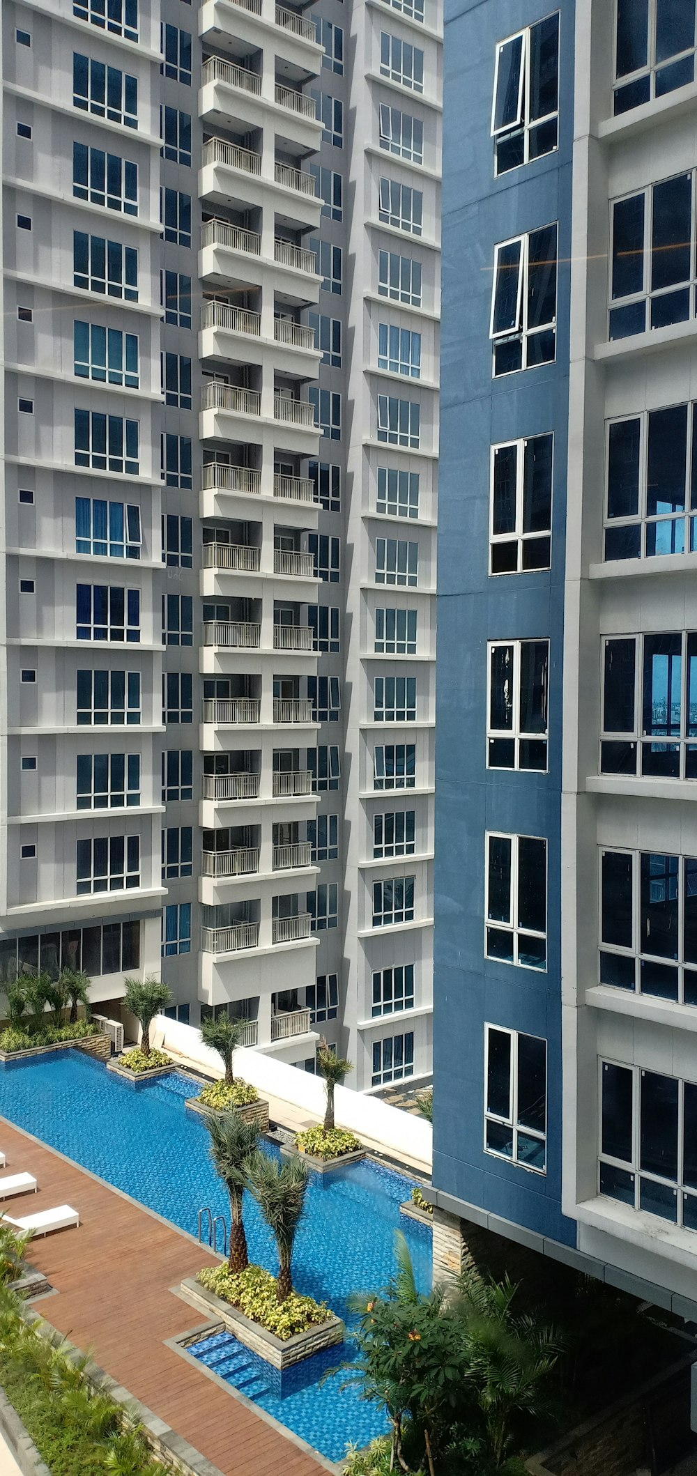 a swimming pool in front of a tall building