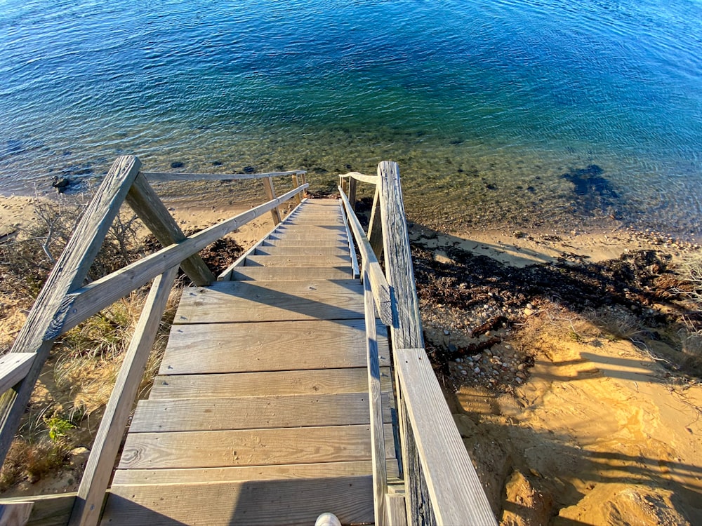 a wooden staircase going down to the water