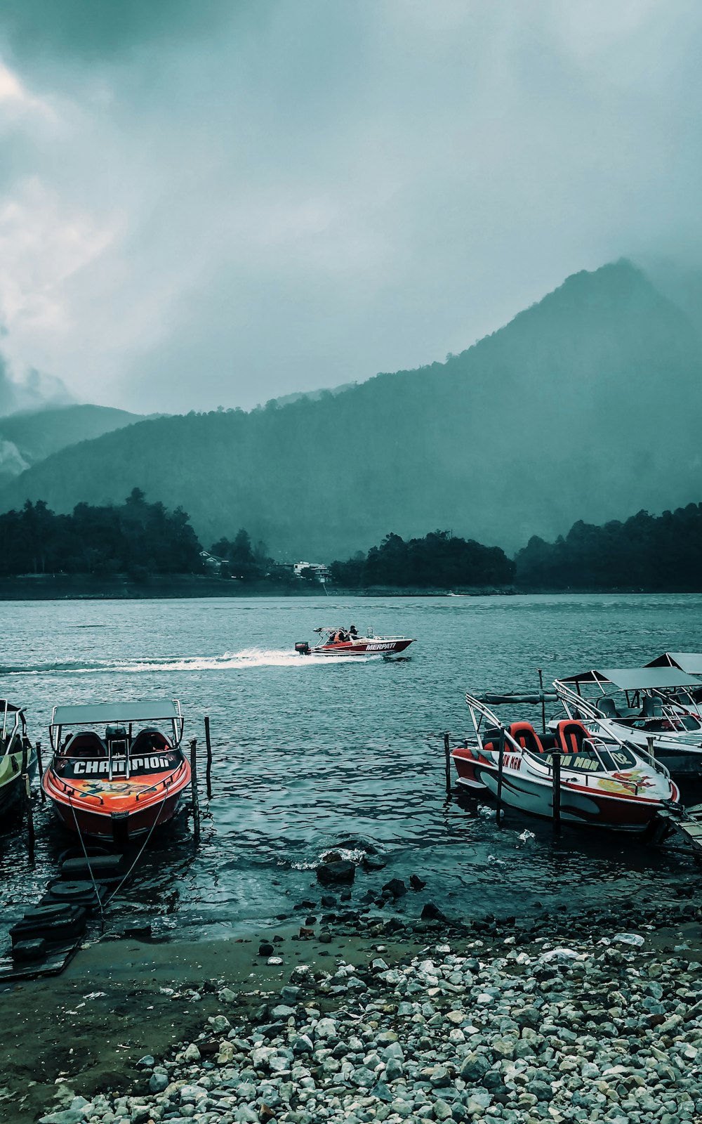 a group of boats floating on top of a lake