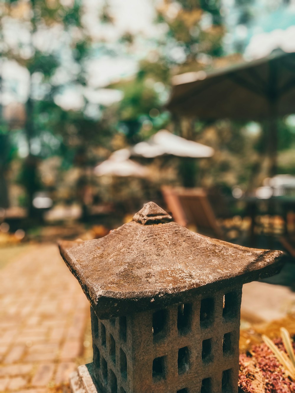 a stone lantern sitting on top of a brick walkway