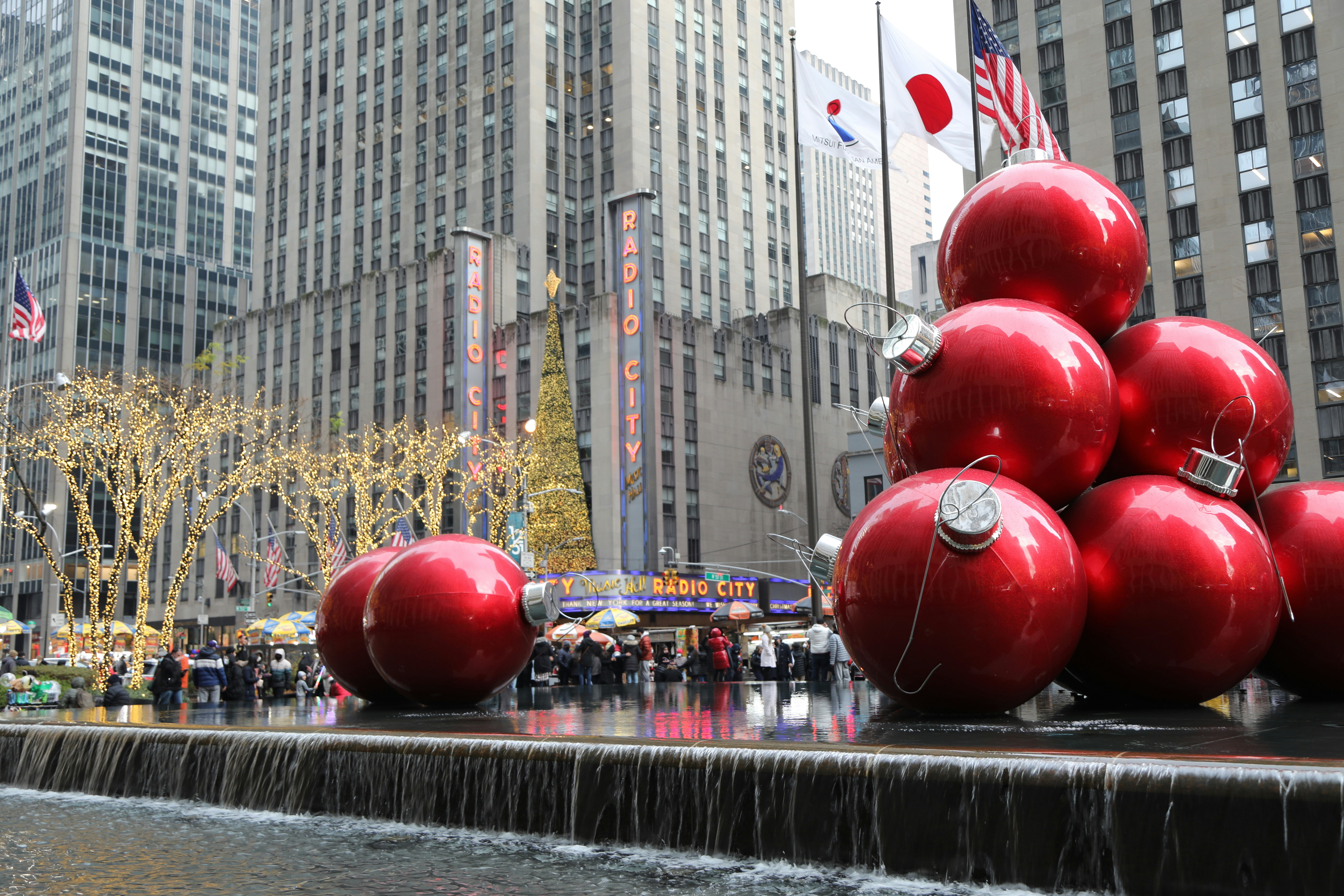 a group of red balls sitting on top of a fountain
