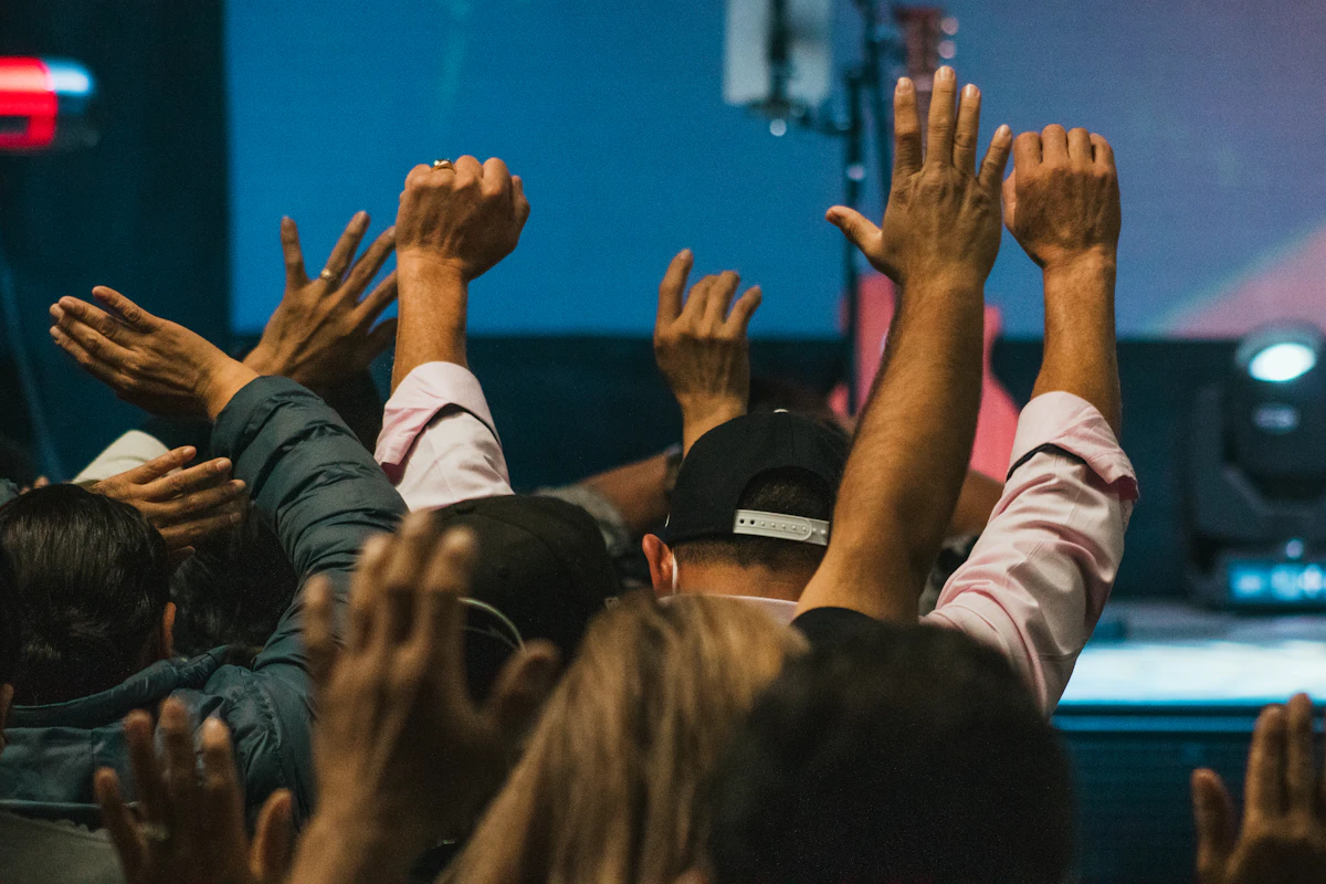 Congregation raising hands together during Christian worship