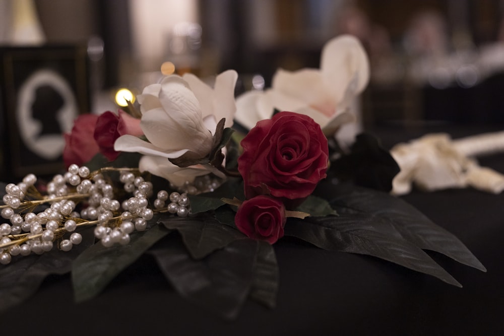 a close up of flowers and pearls on a table