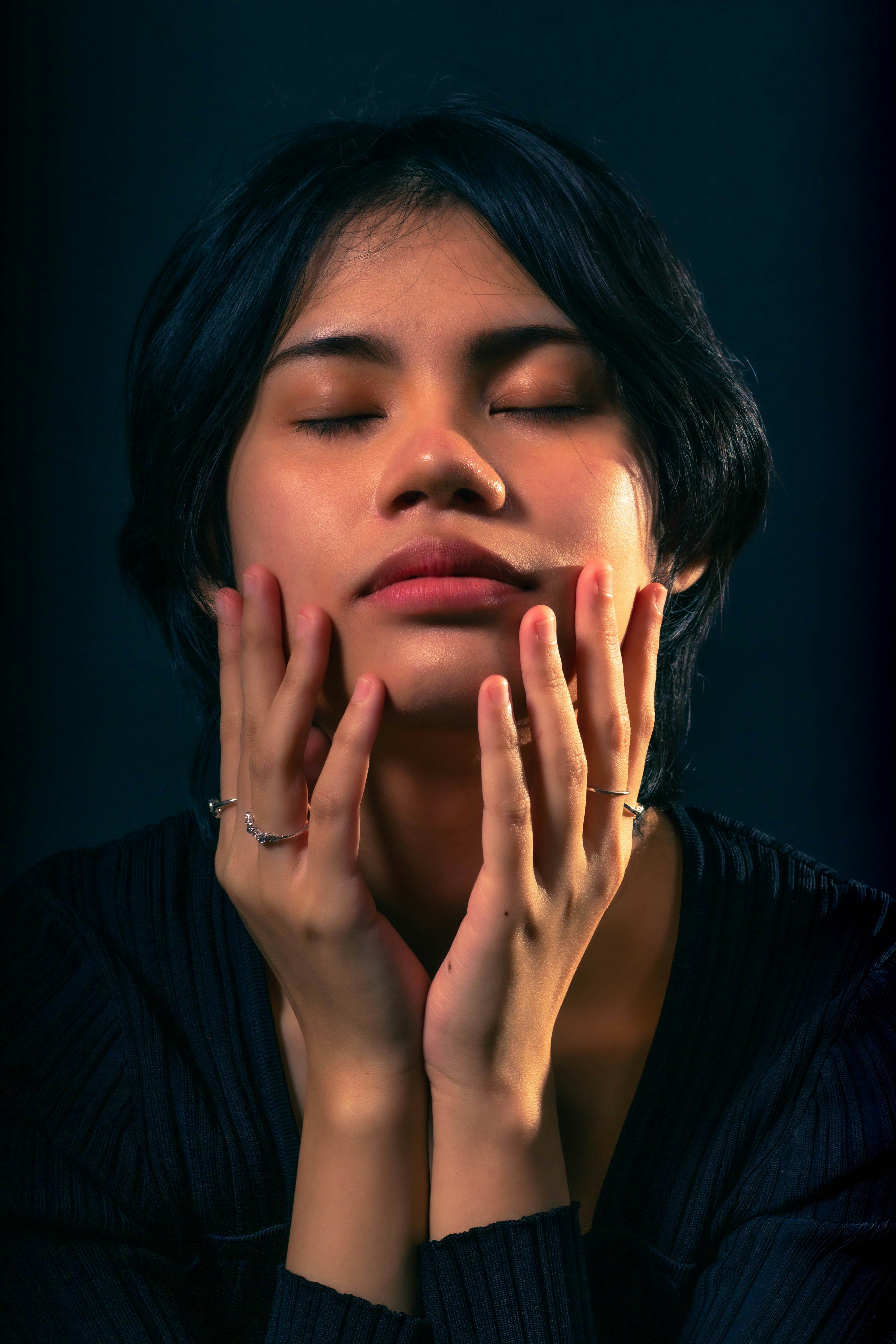 a woman with her hands on her face