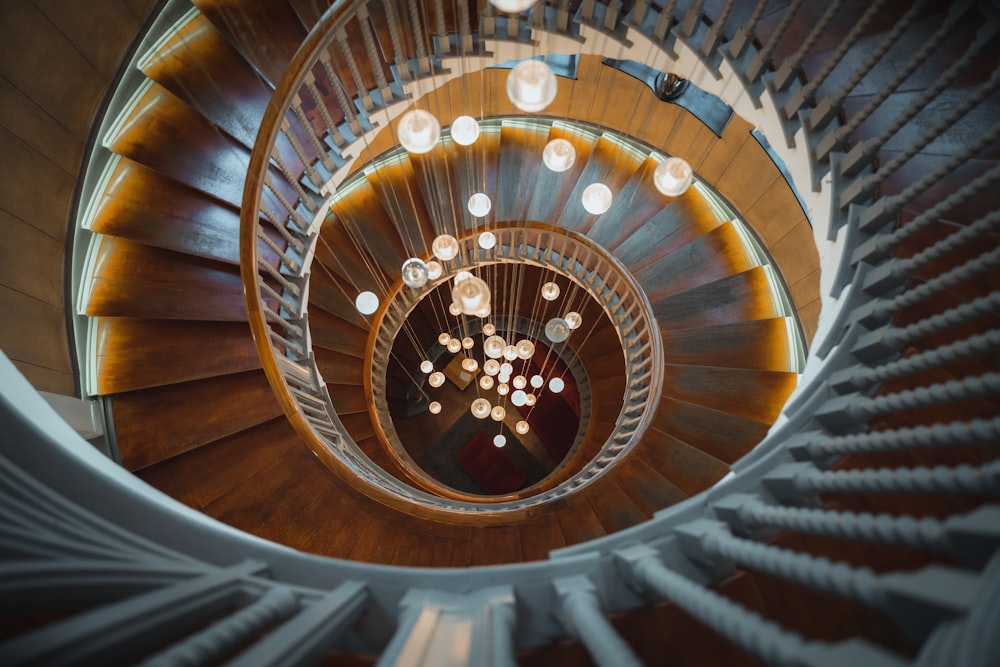 a spiral staircase with lights hanging from it