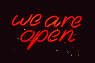 a neon sign that says we are open
