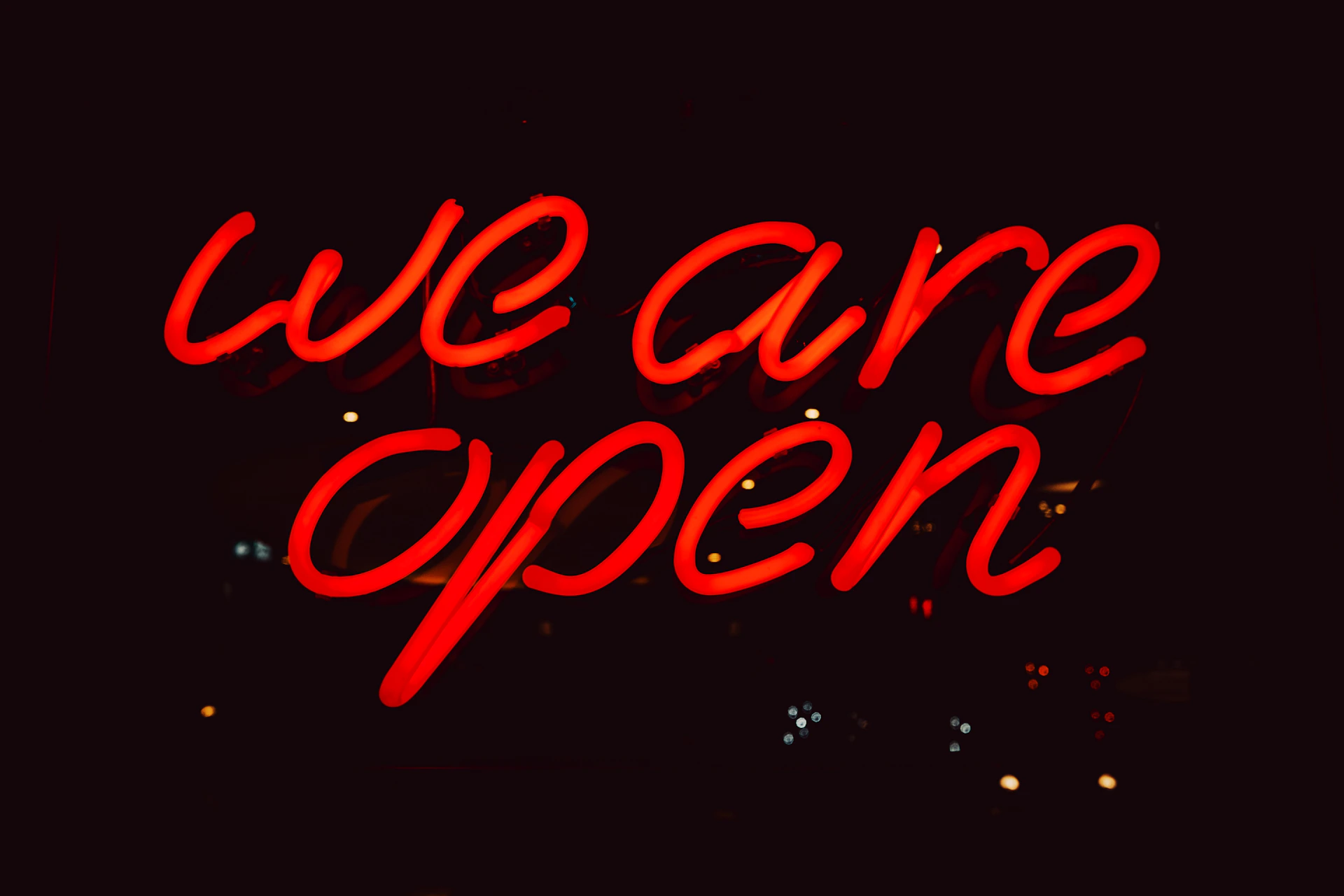 a neon sign that says we are open