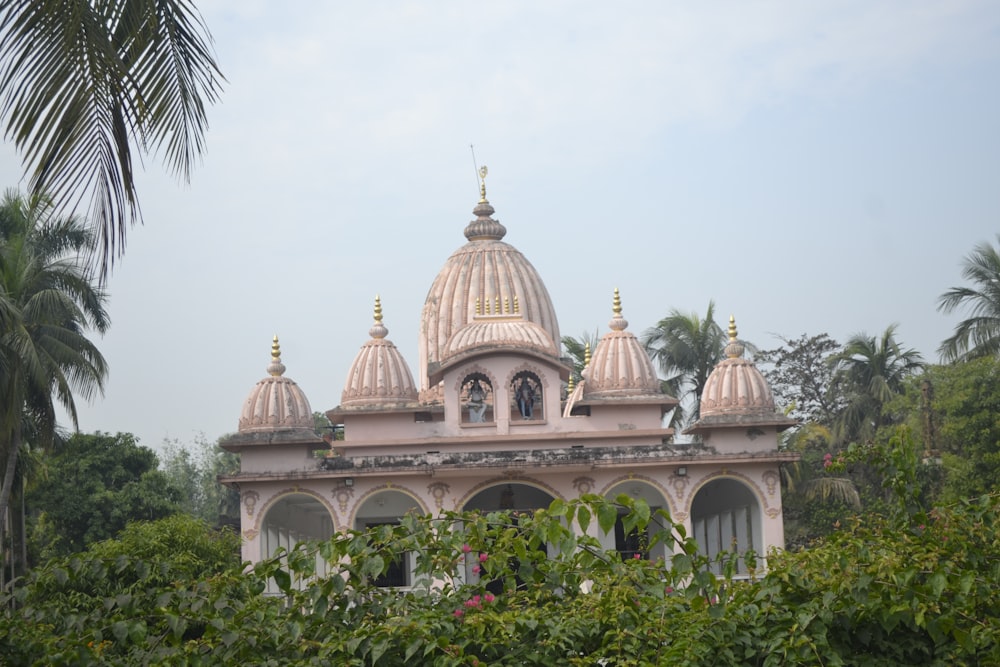 a building with a dome on top surrounded by trees