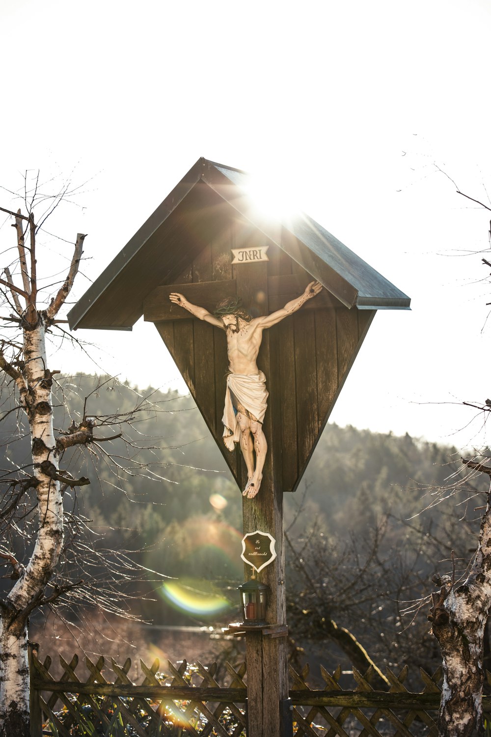 a crucifix in the middle of a forest