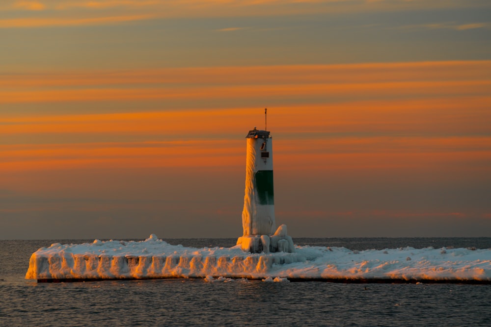 a light house in the middle of a body of water