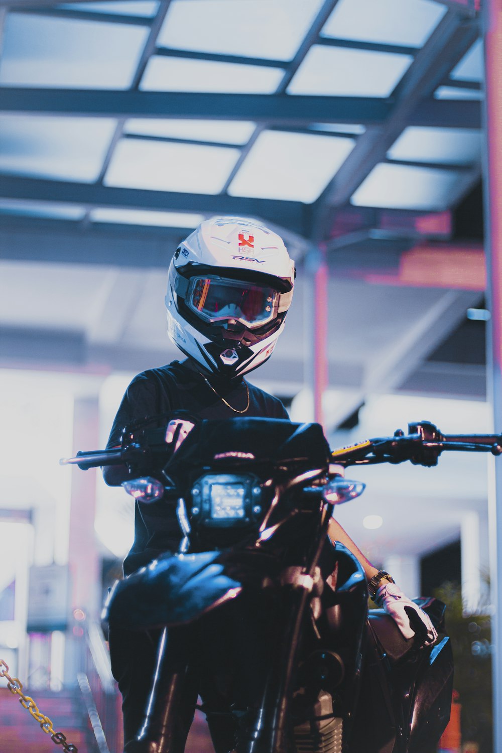 a man in a helmet is sitting on a motorcycle