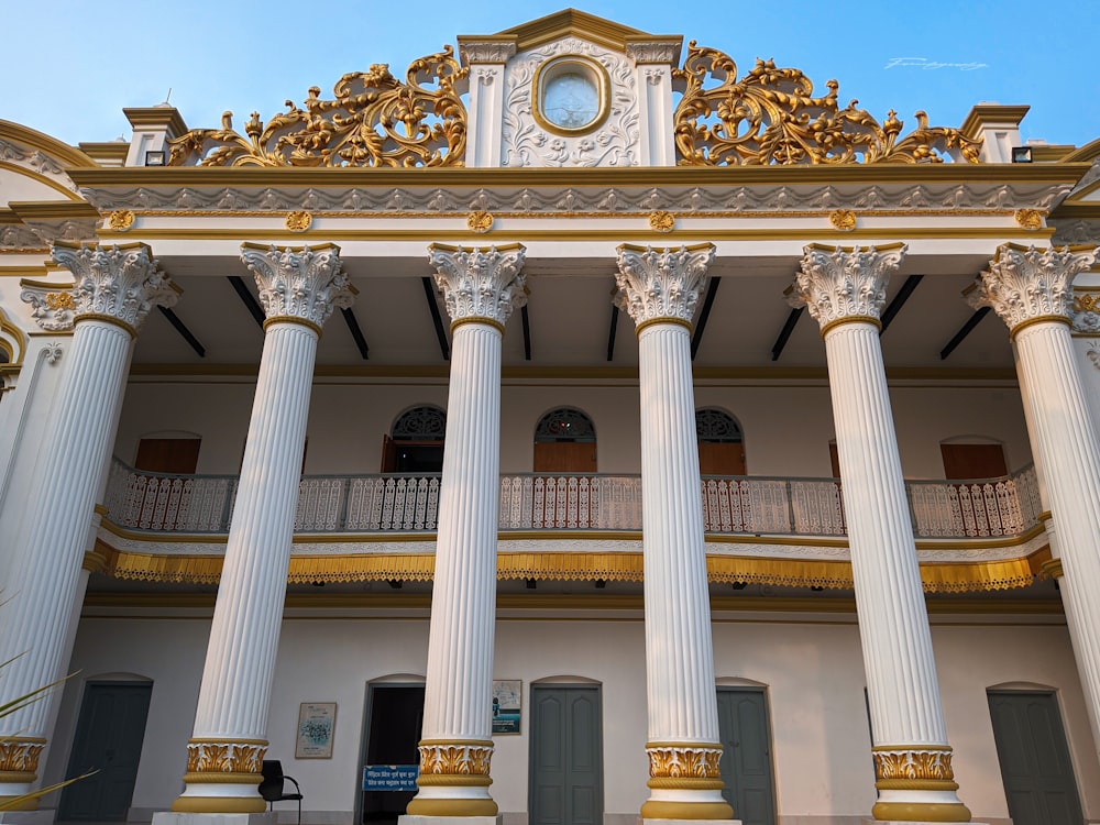 a building with columns and a clock on the top of it